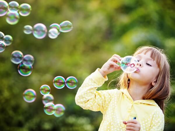 Slo-Motion in Blowing Bubbles